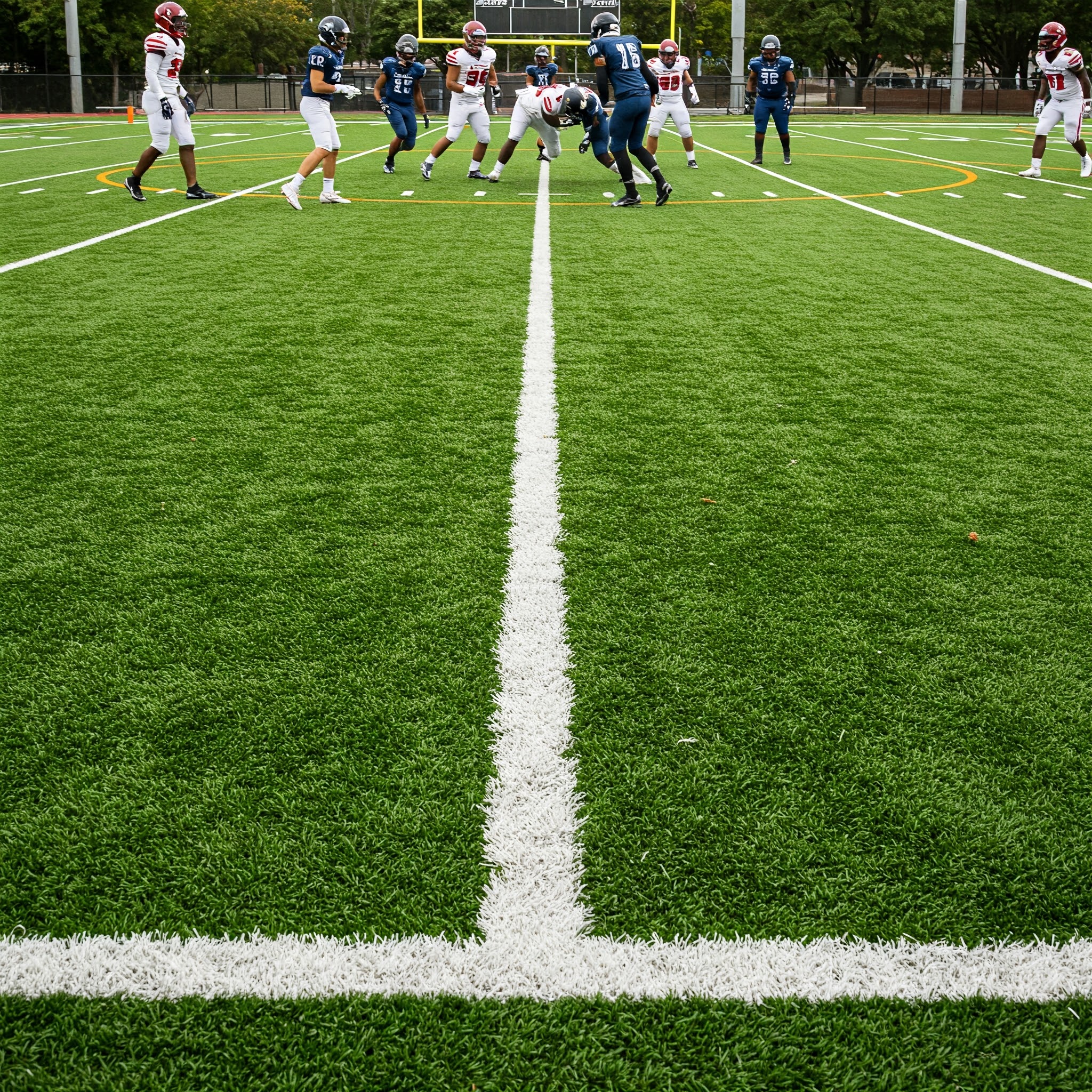 Football Players on Artificial Turf